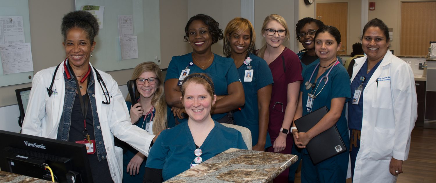 a group of smiling physicians