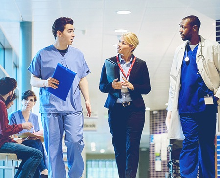 Nurses walking in the hall and talking.