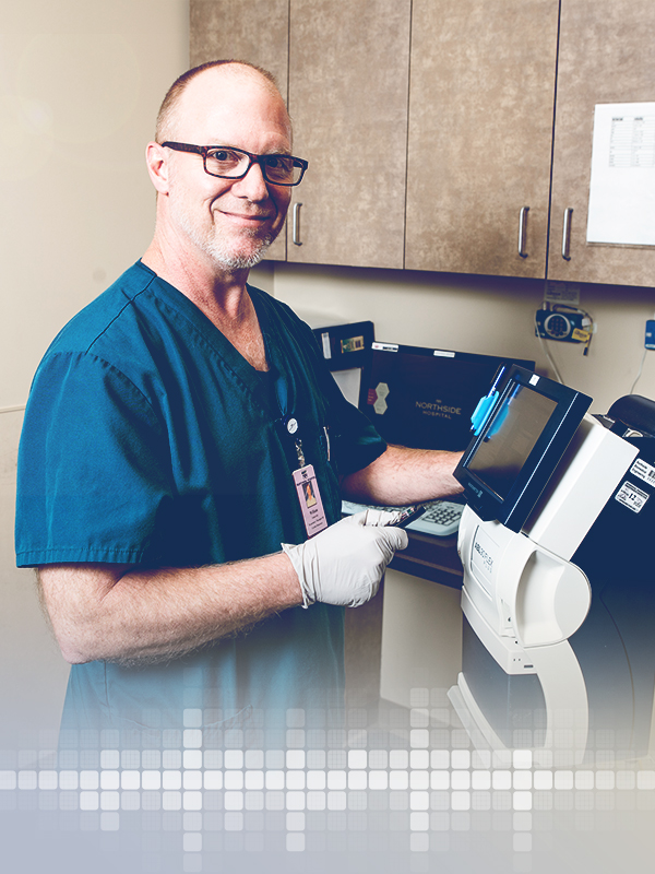 Smiling doctor working on a medical equipment.