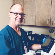 Smiling doctor working on a medical equipment.