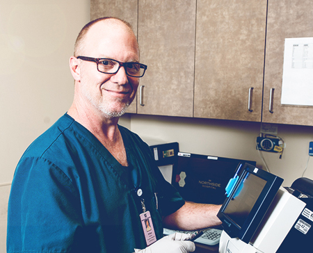Smiling doctor working on a medical equipment.